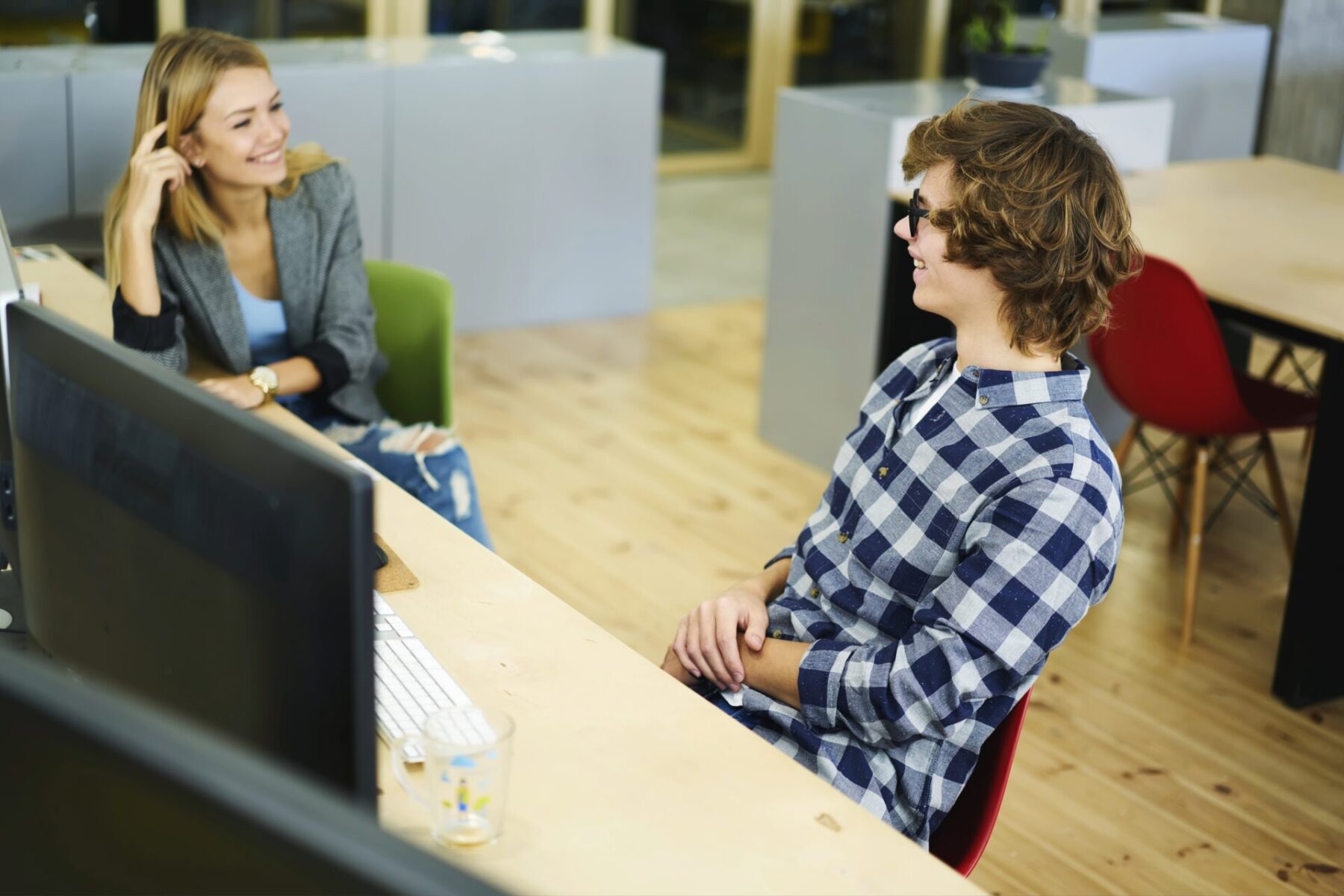 A student sits in next to an interviewer at a table.